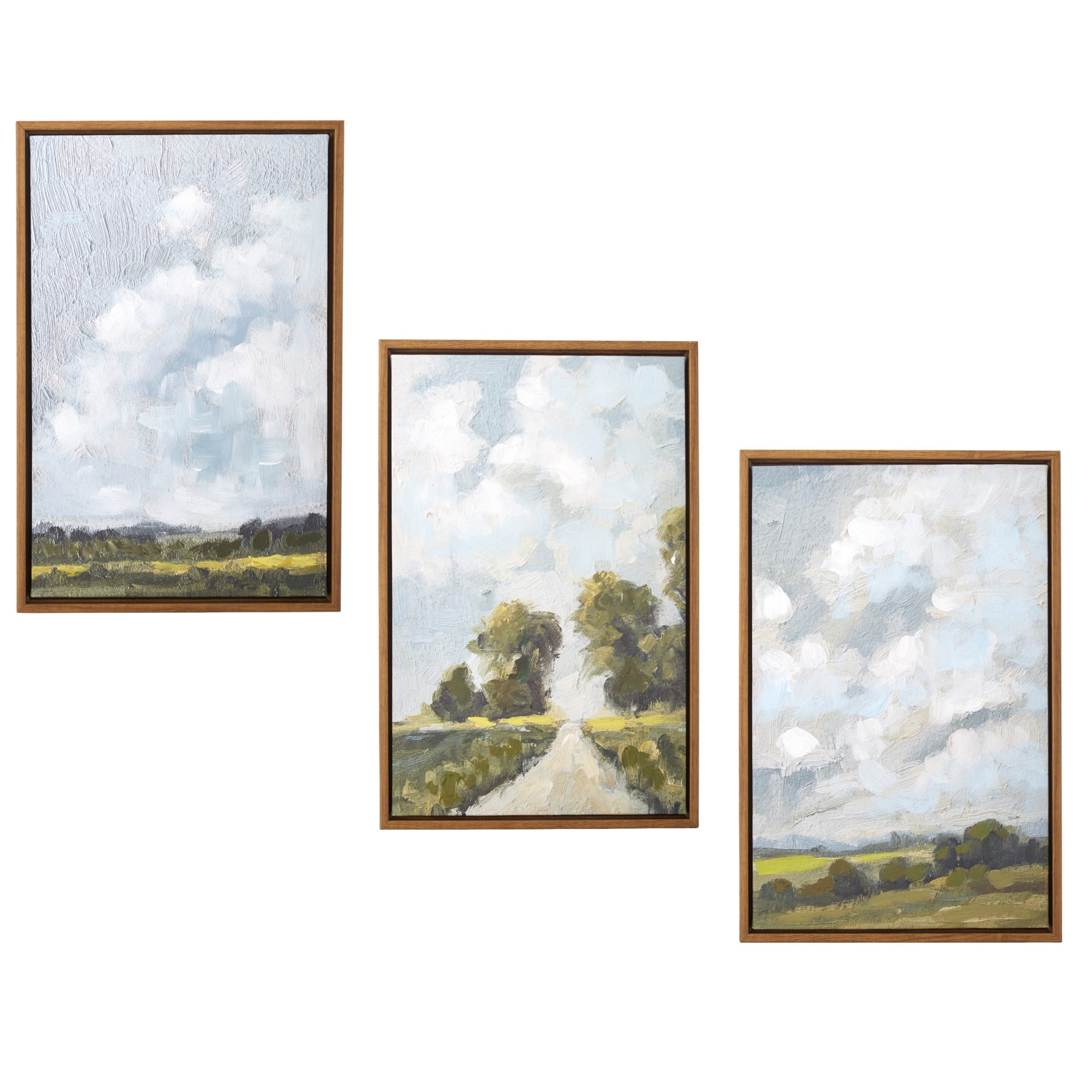 A cloudy sky is juxtaposed against a lush green landscape. Canvas is mounted in a warm silver floater frame with satin black side.